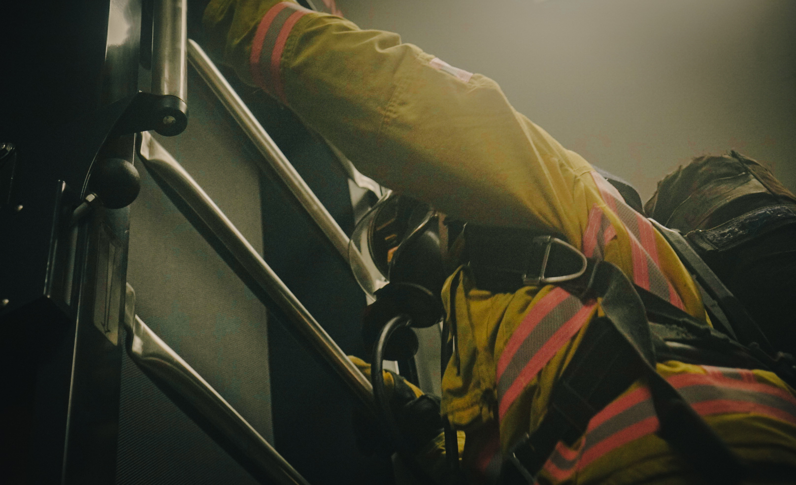 Firefighter climbing ladder