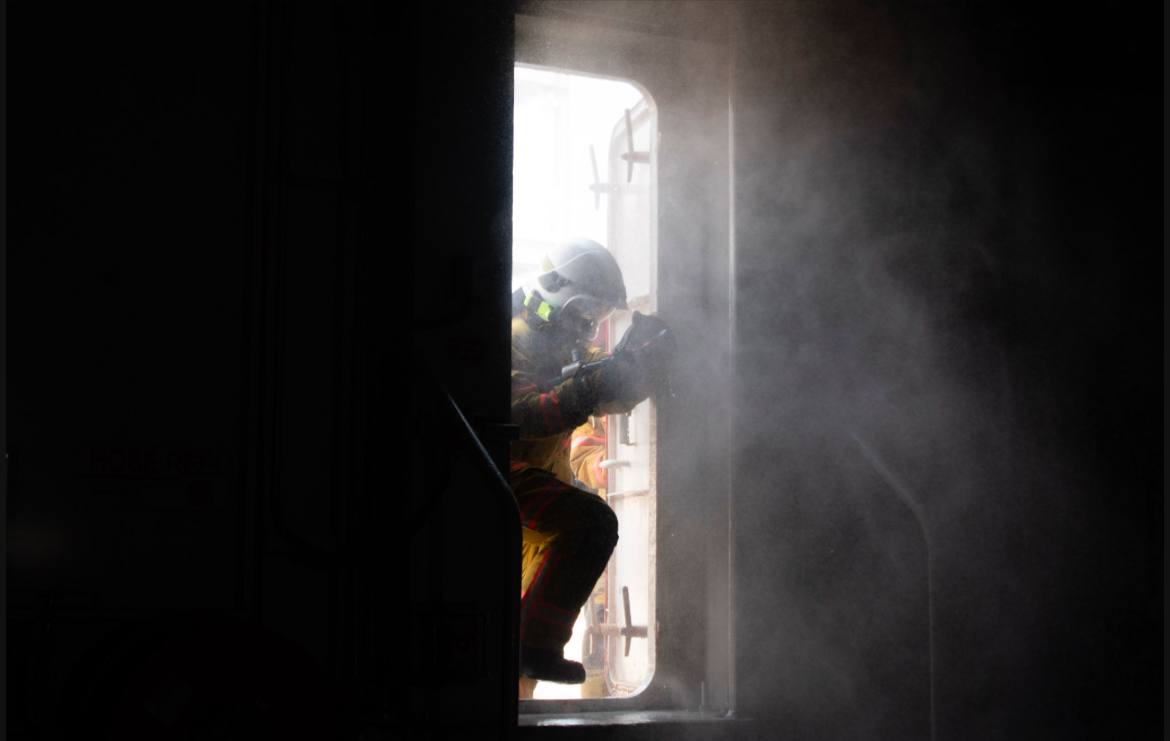 Four firefighters with helmets and suits