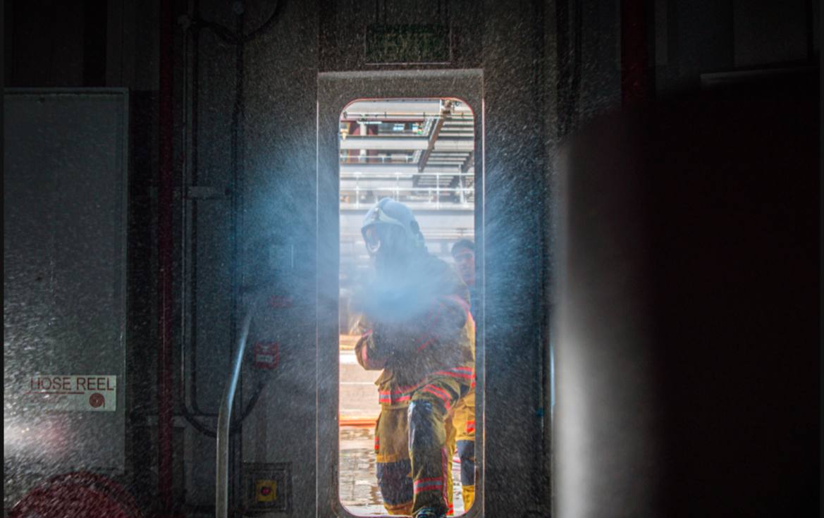 Four firefighters with helmets and suits